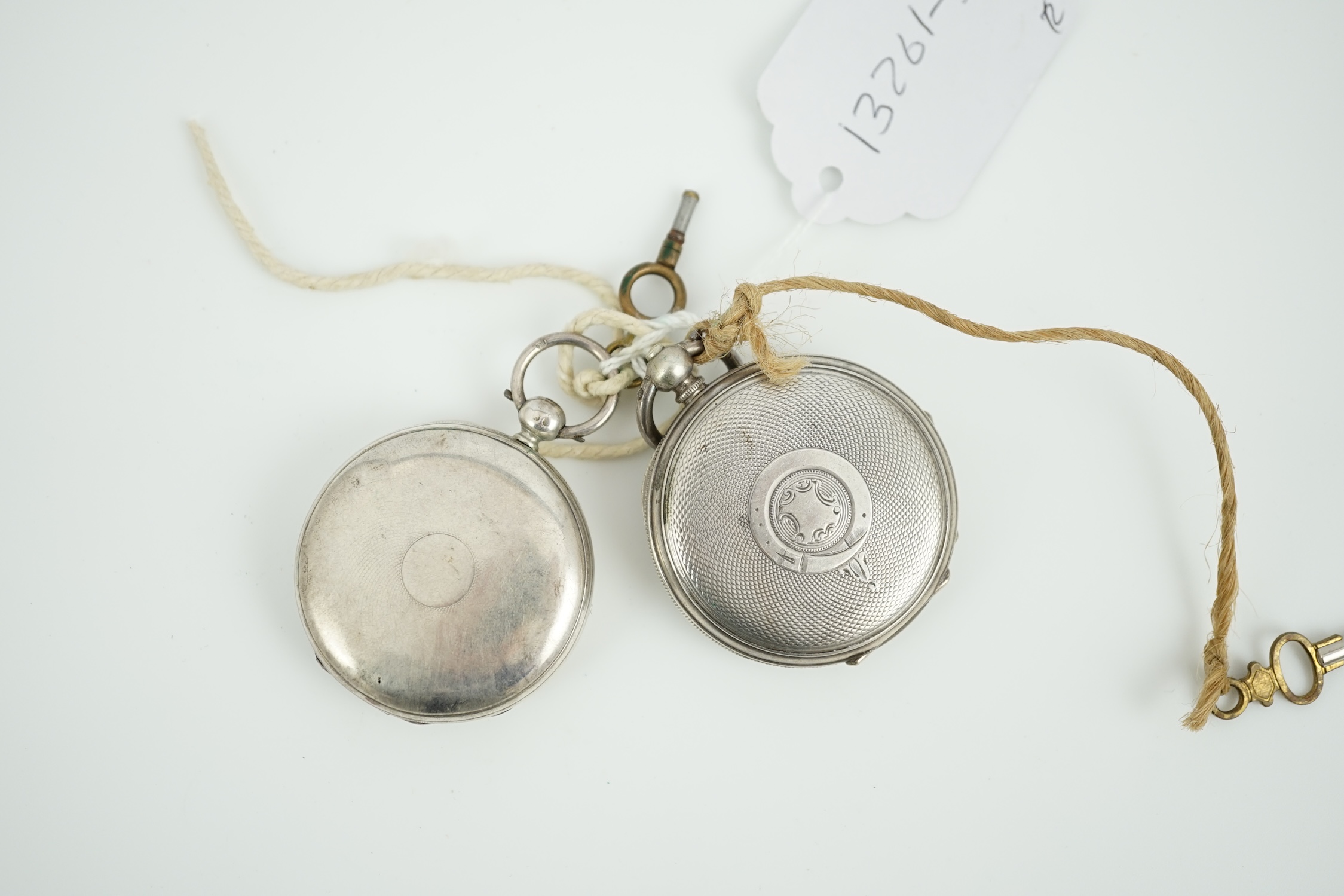 A Victorian silver hunter keywind pocket watch and an engine turned white metal pocket watch.